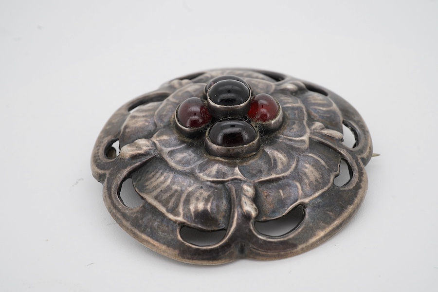 A Danish Georg Jensen sterling 925 and five stone cabochon garnet cluster set circular foliate brooch, design no. 59, 1915-1927 mark, diameter 47mm. Condition - fair to good